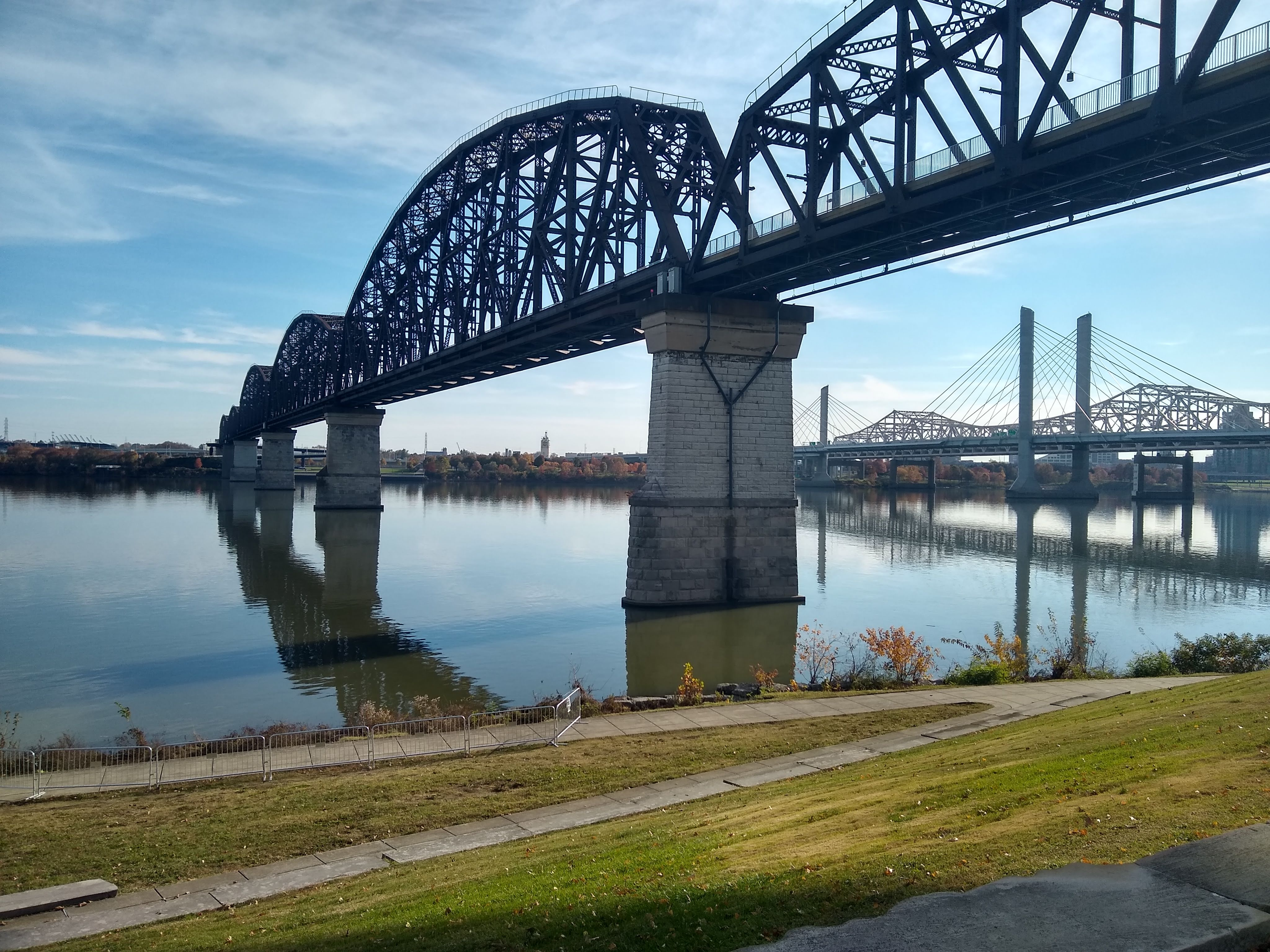 From Van Dyke Park in Jeffersonville, IN, a low-angle shot with the Big Four Pedestrian Bridge in the foreground, and Abraham Lincoln & John F. Kennedy Memorial bridges in the background.