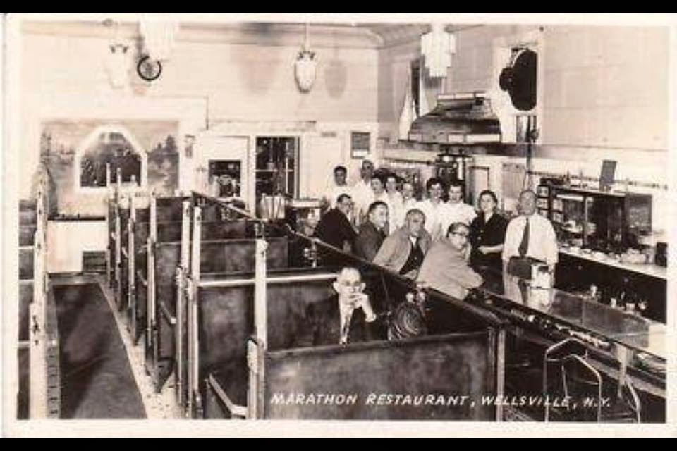 A postcard of the interior of Marathon Restaurant in Wellsville, NY.